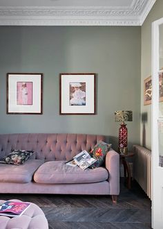 a living room filled with furniture and pictures on the wall