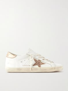 Each variation of Golden Goose's iconic 'Super-Star' sneakers is as cool as the last. This version is made from smooth white leather and distressed by hand to look worn-in from the very first wear. They're detailed with glittered stars and metallic heel tabs. Wear yours with everything from denim to tailored pants. Golden Goose Gold Star, Golden Goose Superstar Gold, Pink Golden Goose, Sneakers Outfit Spring, Designer Sneakers Women, White And Gold Shoes, Golden Goose Superstar, Preppy Shoes, Golden Goose Sneakers