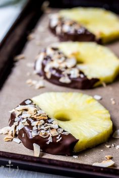 chocolate covered pineapple slices on a baking sheet