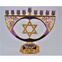 an elaborate menorah with purple and gold decorations