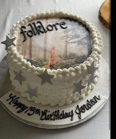 a birthday cake with an image of a person in the woods on it and stars