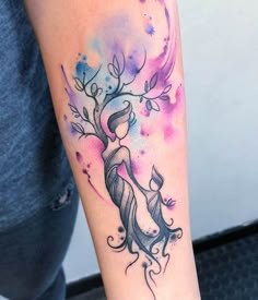 a woman's arm with a tattoo on it and a tree in the middle