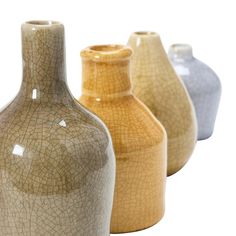 three vases are shown in different colors and sizes, each with a cracky surface