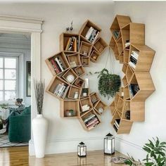 a living room filled with furniture and bookshelves next to a wall mounted book shelf