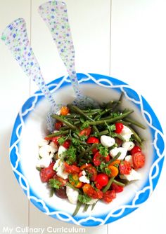 a blue and white bowl filled with vegetables