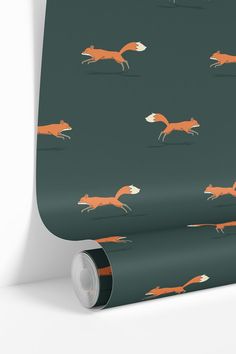 a green wallpaper with an orange fox pattern on the front and back of it