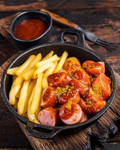 hot dogs and french fries in a pan with ketchup