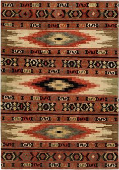 an old navajo rug with red, green and beige designs on the bottom half of it