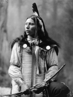 an old black and white photo of a native american man