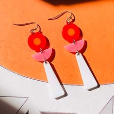 "Colorful earrings to accent your day! Made from 1/8\" thick white, pink, red, and orange acrylic. Earrings measure approximately 2-1/4 inches long x 3/4 inch wide and have stainless steel hooks. We draw, cut, and assemble each piece by hand.  Some small variations and imperfections are part of the process which make each item unique! Made in Los Angeles, California. Visit our website: www.getmadeinla.com Join us on Instagram: @getmadeinla" Artsy Accessories, Rose Rouge, Acrylic Jewellery, Red And Orange, Post Modern, Colorful Earrings, Acrylic Earrings, Clay Jewelry, Statement Pieces