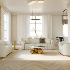 a living room filled with white furniture and gold accents