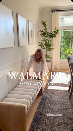 a woman standing in front of a window next to a rug