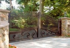 an iron gate in the middle of a driveway