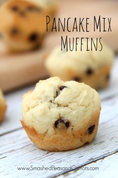 a close up of a muffin on a table with other muffins in the background