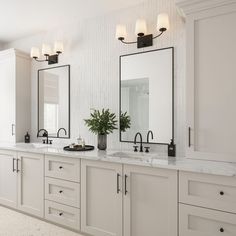 a large bathroom with double sinks and two mirrors on the wall next to each other