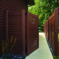 a walkway between two brown wooden fences