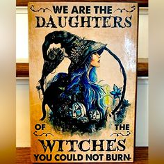 there is a sign that says we are the daughters of witches you could not burn