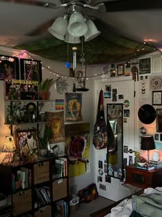 a room with many pictures and decorations on the walls, including a ceiling fan that is hanging from the ceiling