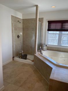 a bathroom with a large tub and walk in shower