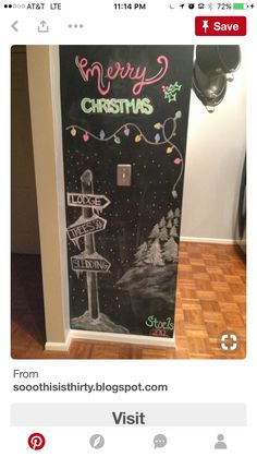 a door decorated with chalk and christmas lights