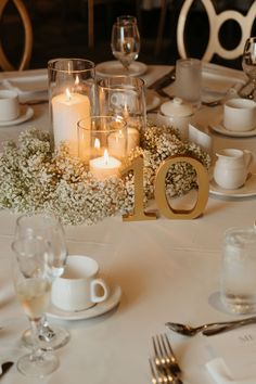 the table is set with candles and flowers