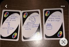 three playing cards with instructions on them sitting on a table