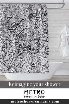 a shower curtain with black and white graffiti on it in front of a brick wall