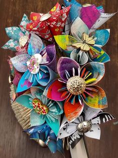 a bunch of colorful paper flowers in a vase