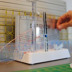 a model of a building being constructed with rulers and measuring tape on top of it