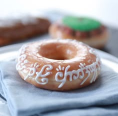 a frosted doughnut sitting on top of a napkin