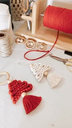 yarn, beads and other crafting supplies on a table with wooden spools