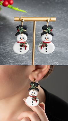 the snowman earrings are decorated with red and green ribbon on it's ear wires