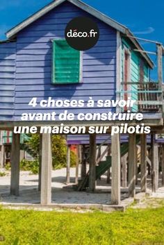 a blue house with green shutters and the words, 4 choses a savoir avant de construire une & une maison sur pilotes