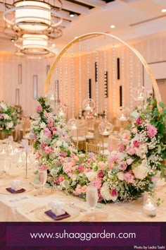 a table with flowers and candles on it for a wedding reception at the sherata garden