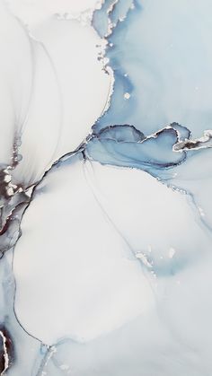 an abstract painting with blue and white paint on the water's surface is shown