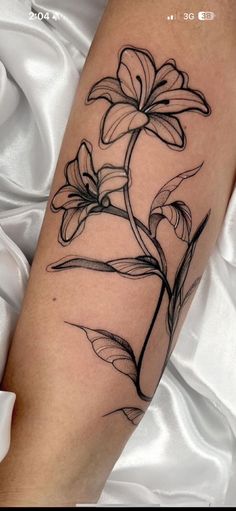 a black and white flower tattoo on the leg