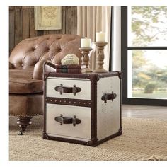 a white and brown trunk sitting on top of a rug in front of a couch