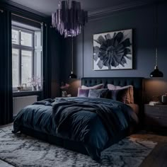 a bedroom with dark blue walls, black bedding and chandelier hanging from the ceiling