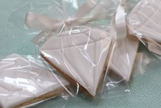 some cookies are wrapped in plastic and tied with a white ribbon on the top one is shaped like an origami