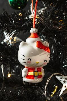 a hello kitty ornament hanging from a christmas tree