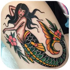 a woman with long hair sitting on top of a mermaid tail tattoo done by person