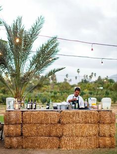 a man sitting at a bar made out of hay