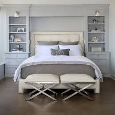 a bedroom with white furniture and gray walls