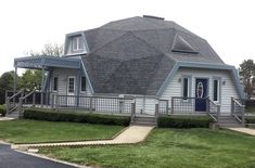 a white house with a gray roof and blue trim