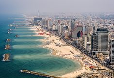 an aerial view of a city and the ocean with buildings on both sides, including beach