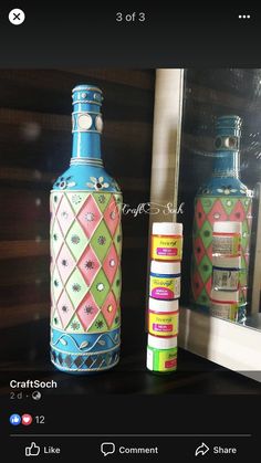 two bottles are sitting on a shelf next to each other, one is blue and the other is pink