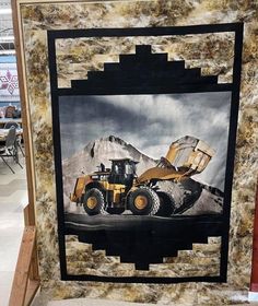 an image of a construction truck quilt on display