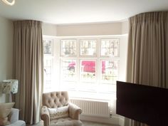 a living room filled with furniture and a flat screen tv