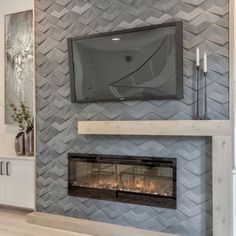 a fireplace with a flat screen tv mounted on it's wall above the fire place