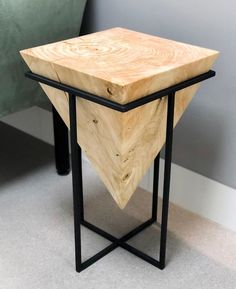 a wooden table sitting on top of a metal frame